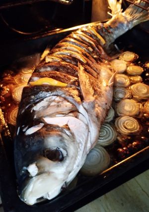 Товстолоб запечений на цибулевій подушці з лимоном